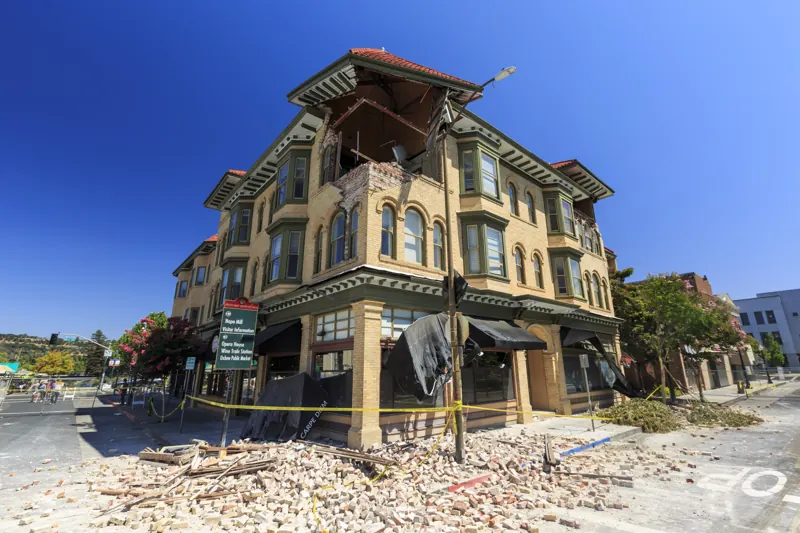 Brick commercial building in Napa with its upper corner collapsed onto the sidewalk after the 2014 earthquake